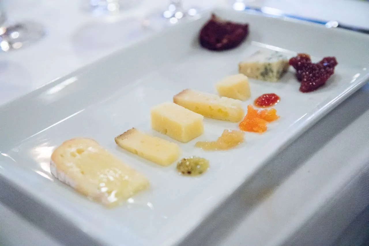 An opulent cheese plate with six different cheeses. 