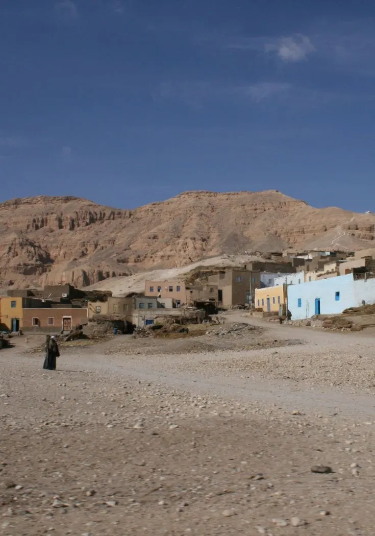 A man walking in an Egyptian village.