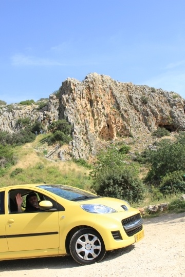 Jim waves from the window of our yellow rental car at Mount Carmel, Israel.