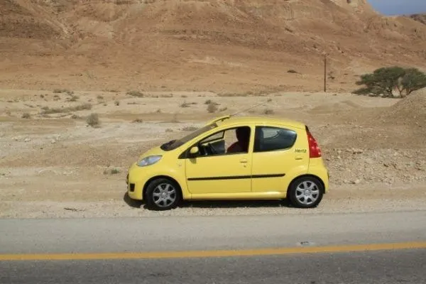Our little yellow rental car parked in the Negev desert.