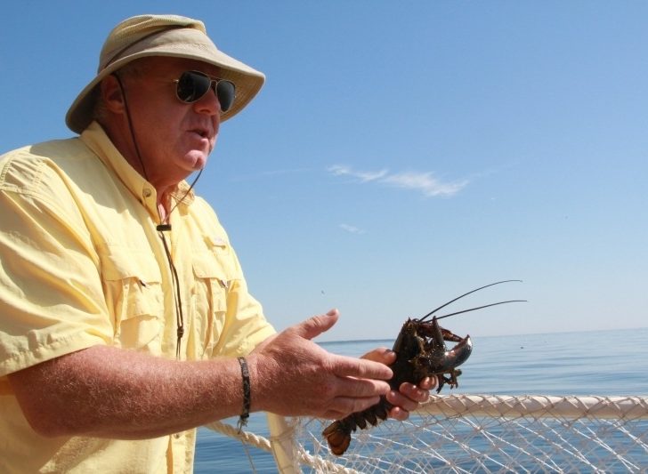 Our guide holds a lobster during our Lobster Tour in New Hampshire.