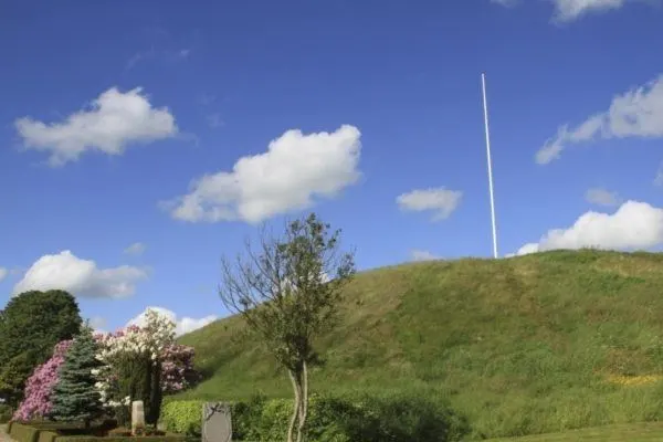Burial mound with flagpole in Jelling, Denmark.