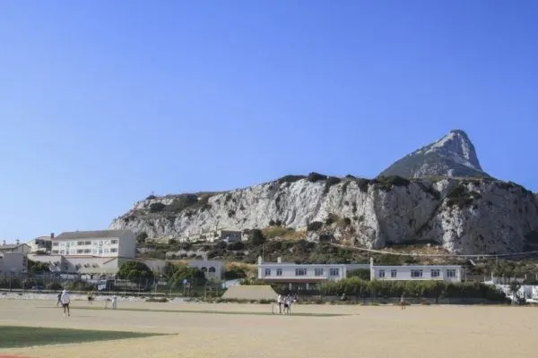 Gibraltar cricket match with the rRock in the background.