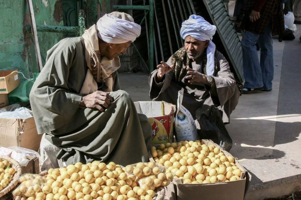Vendors selling lemons at a local market.