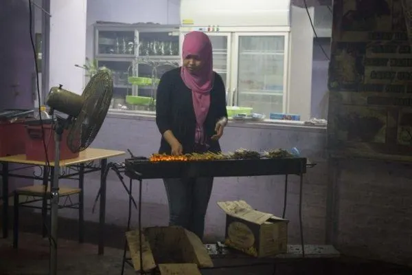 Frilling up some tasty meat sticks at one of Brunei's hawker stalls.