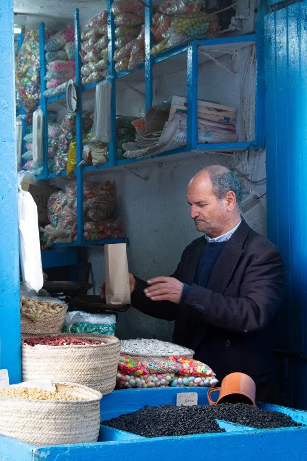 A vendor selling snacks and nuts in the Tunis souk.