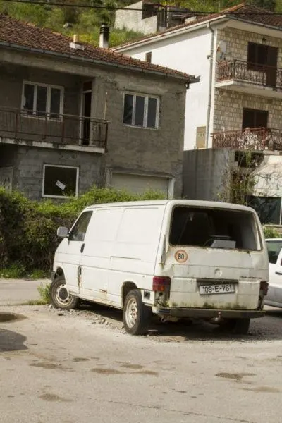 Old van surrounded by rubble in Bosnia.