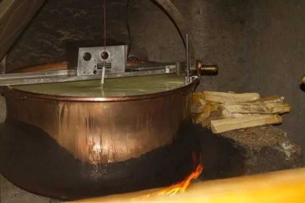Boiling the milk to make cheese.