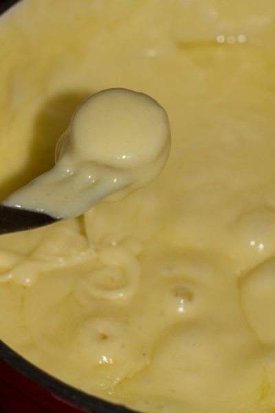 Bubbling fondue cheese, ready to eat.