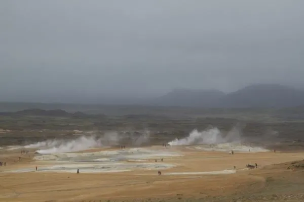 Sulfur pits and steam billowing from the ground at Námafjall Geothermal Area.