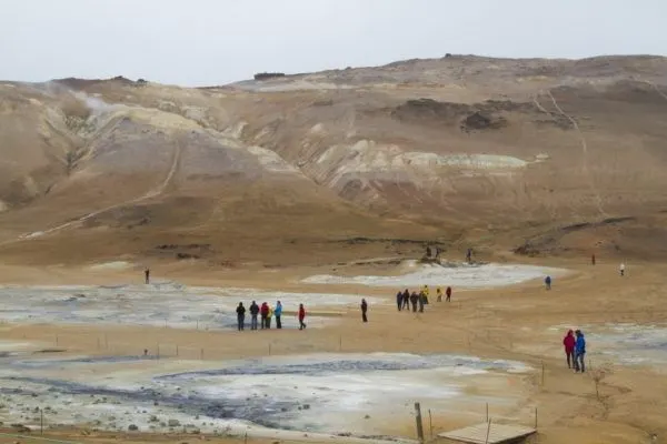 Visitors walk the paths around the boiling mud pots and sulfur pits.