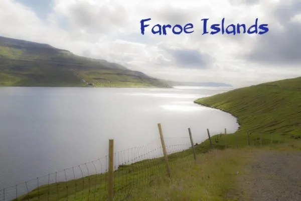Beautiful view of the ocean and the grass covered slopes of the Faroe Islands.
