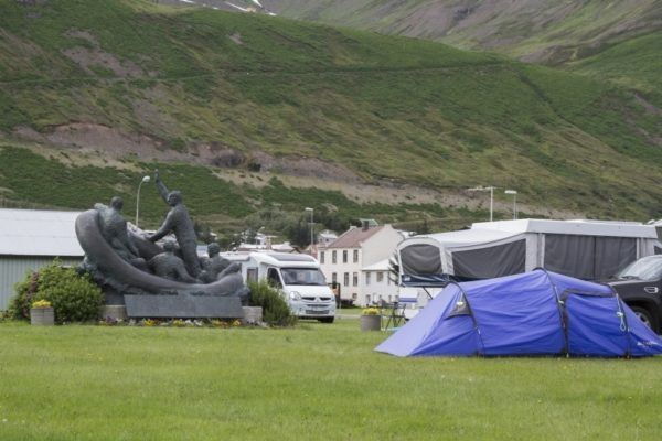 Different types of camping setups in a free Iceland campground.