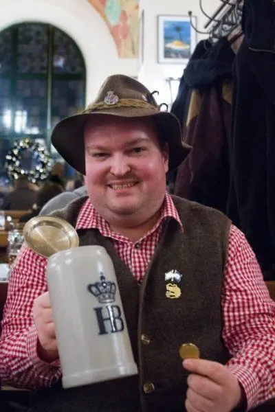 A long time Hofbrauhaus fan, the man shows off his coin and stein.