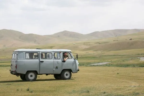 Jim looks out the passenger window of a Russian Military style van in Mongolia.