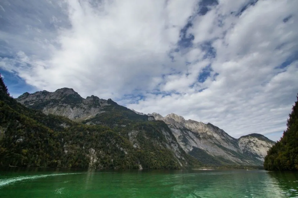 Emerald green waters of Konigsee surrounded by Alpine mountains. 