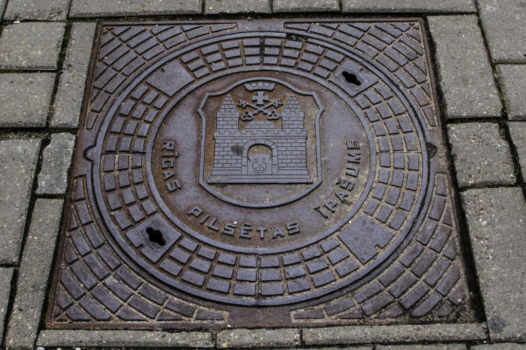 Riga manhole cover with city shield.