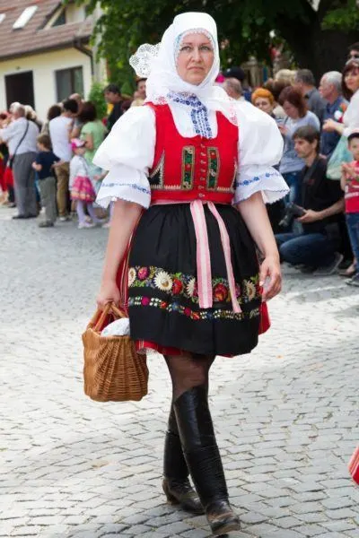 Woman in traditional Czech red and black dress with emroidered flowers.