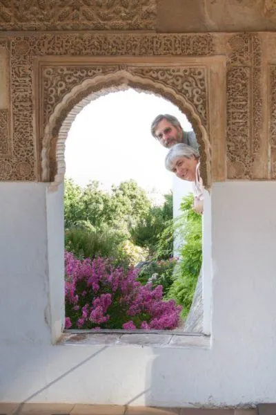 Peeking through an arched window in the Alhambra.