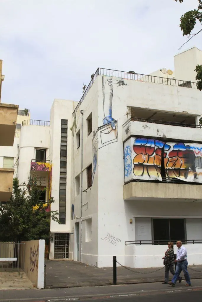 Grafitti adorns the white walls of a Tel Aviv apartment building.