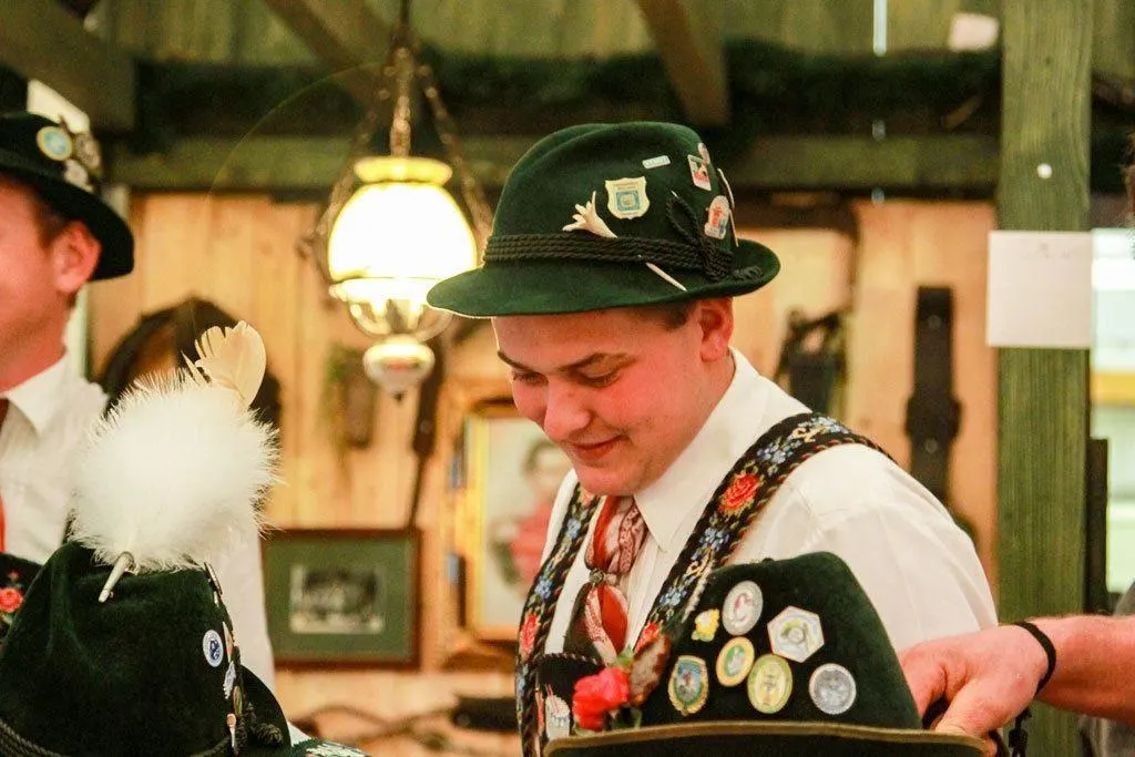 Green hats with medallions and feathers are part of the band's wardrobe. 