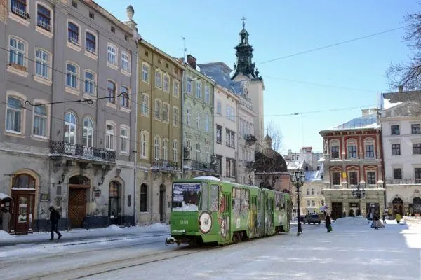 Green street car on a snowy day in Lviv, Ukraine.