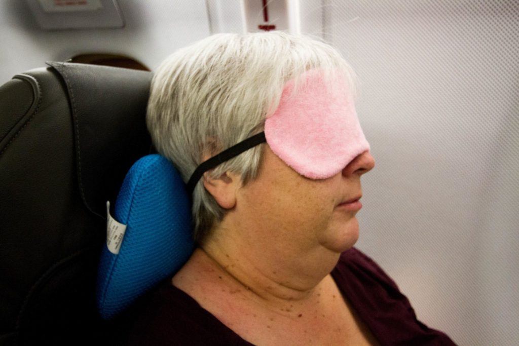 Corinne snoozing comfortably on the flight to help fight jet lag.