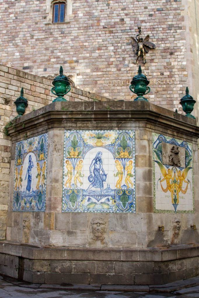 Colorful tiles decorate a city well in the Barcelona Gothic Quarter.