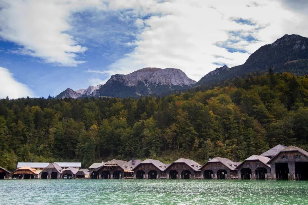 The wooden boathouses lining the northern shore of Koenigssee mark the end of the ride for returning boats.