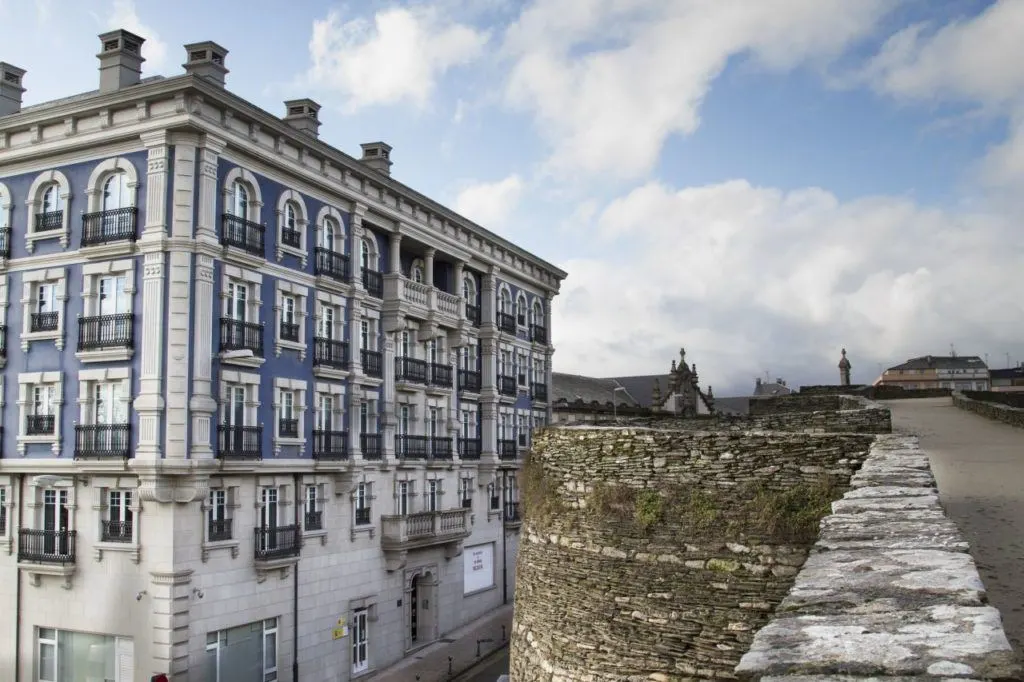 A beautiful blue and white building from on top of the roman wall at Lugo.