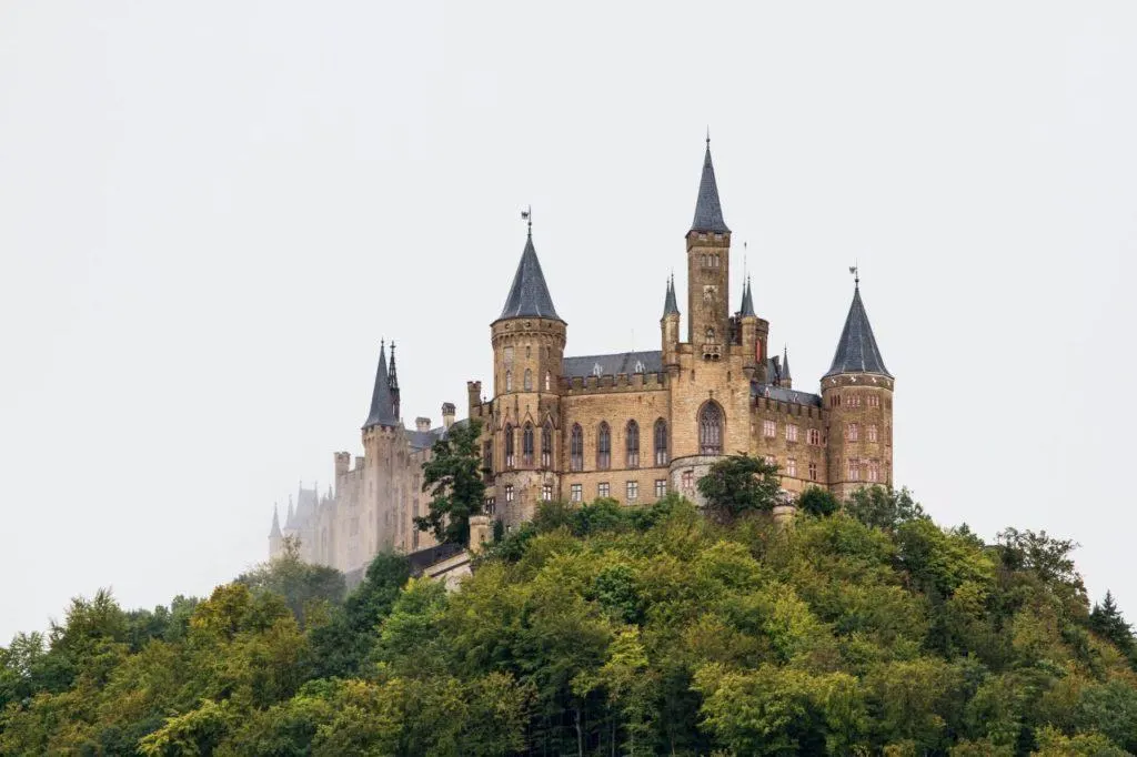 Hohenzollern Castle Germany stands on a hill shrouded in fog.