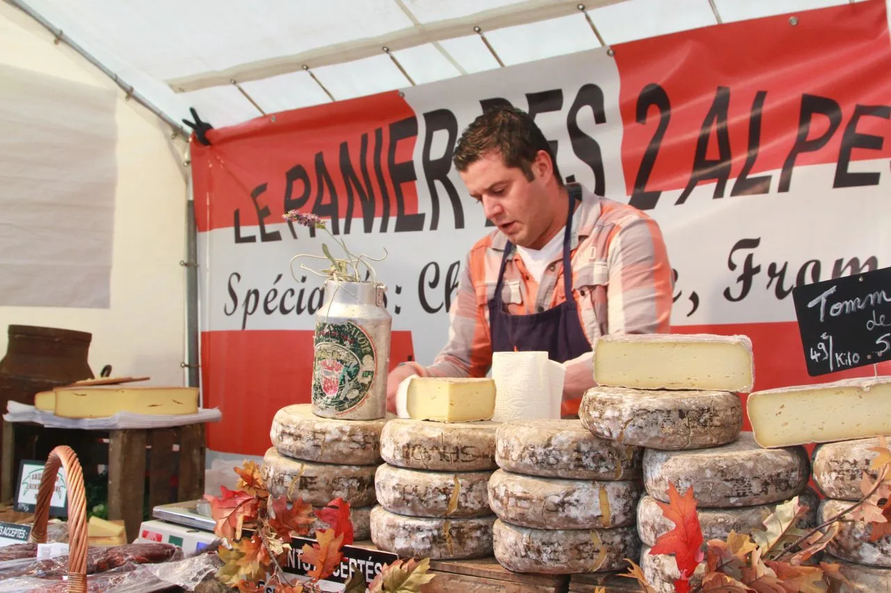 A cheesemonger at a street festival in Montmartre.