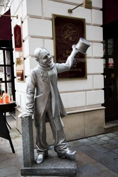 Smiling man sculpture welcomes visitors to old town Bratislava.