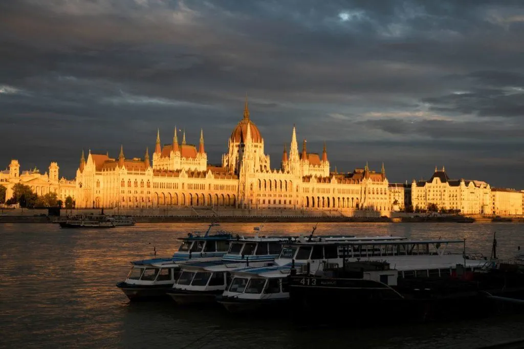 Hungarian Parliament Building bathed in golden sunlight.