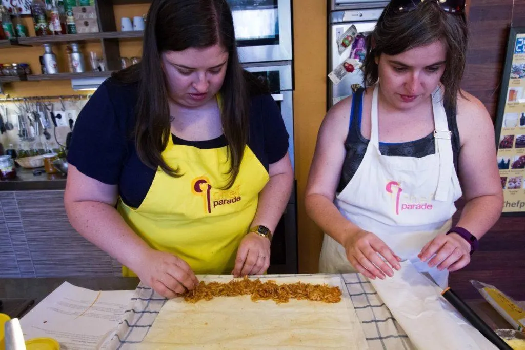 Devon and Erika lay out the apples in the phyllo dough for the apple strudel.