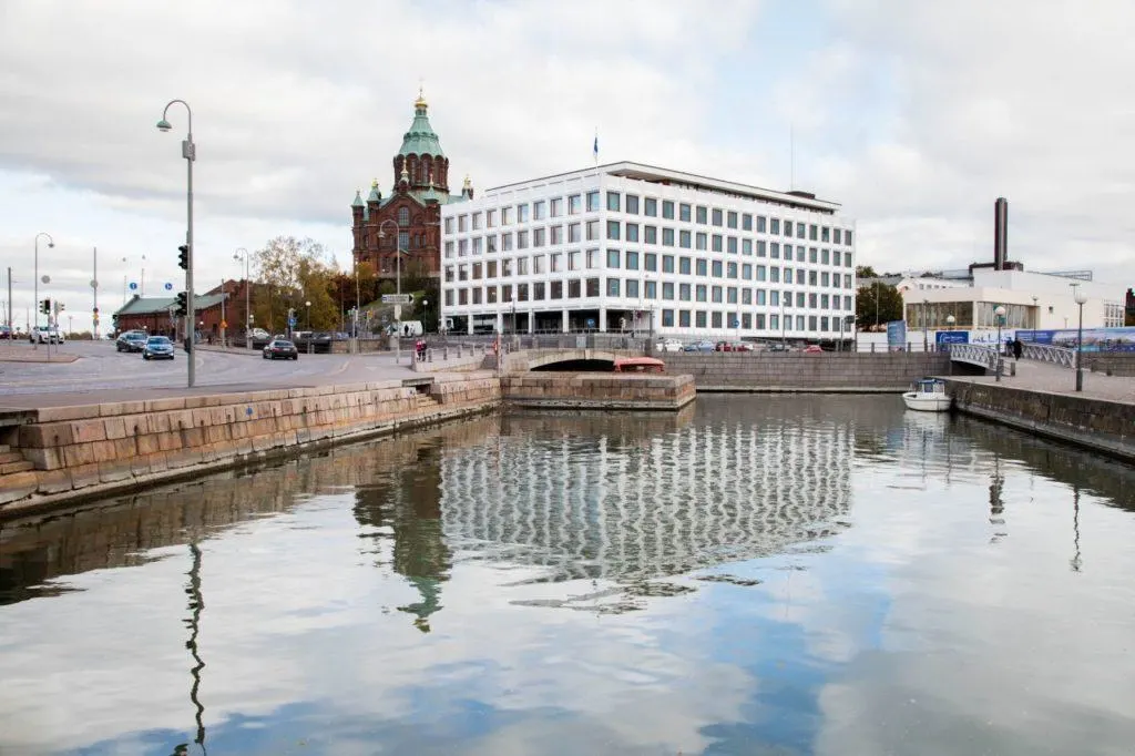 The striking Stora Enso building reflecting off the water in Helsinki harbor.