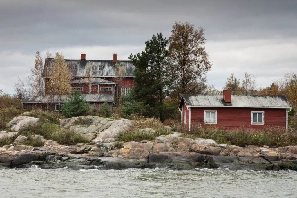 Charming red houses near the water in Finland. 