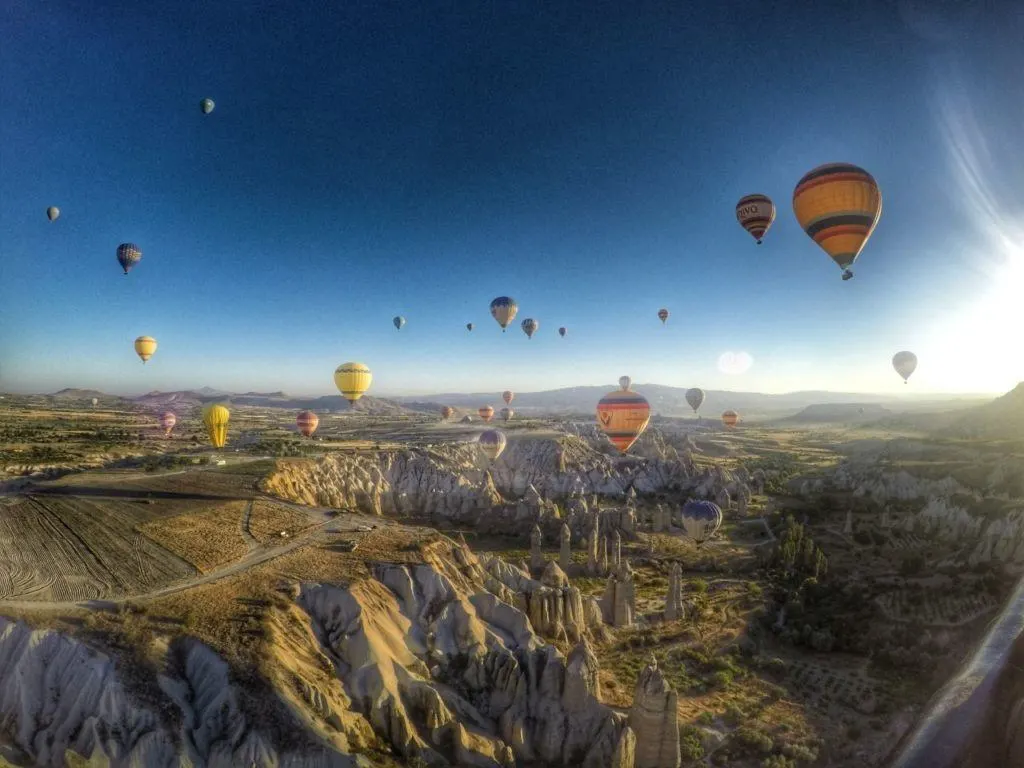 Hot air balloons fly over the fairy chimneys of Cappadocia, Turkey.