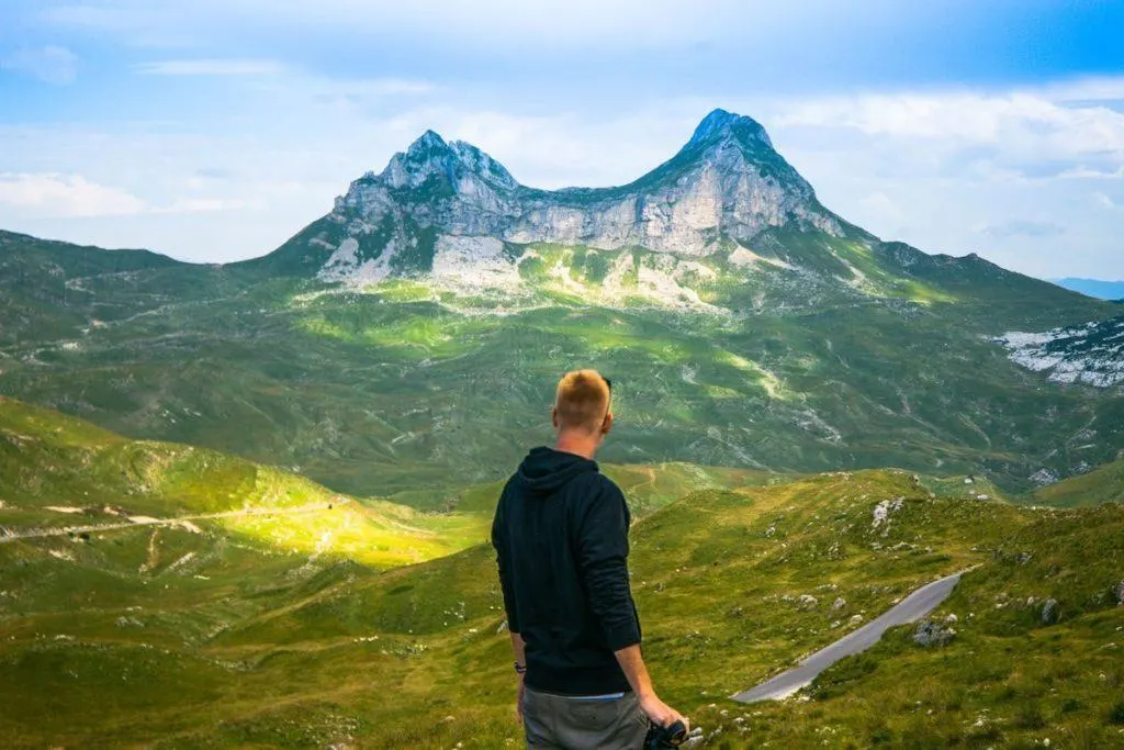 Dave looks out over the lush valley and jagged mountain peaks at Durmitor National Park in Montenegro.