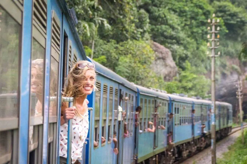 Hannah looks out the open door of the train in Sri Lanka.