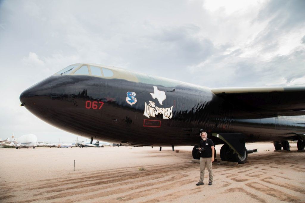 Jim stands next to a B-52, one of the types of planes he worked on when he was in the Air Force.
