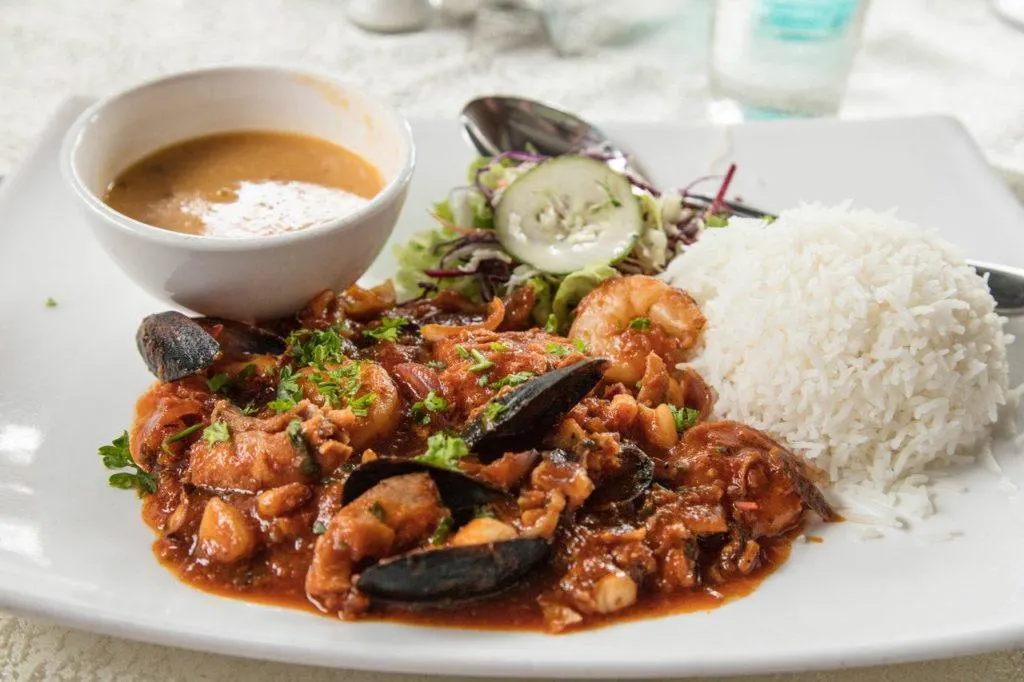 Seafood curry plate with rice and sauce.