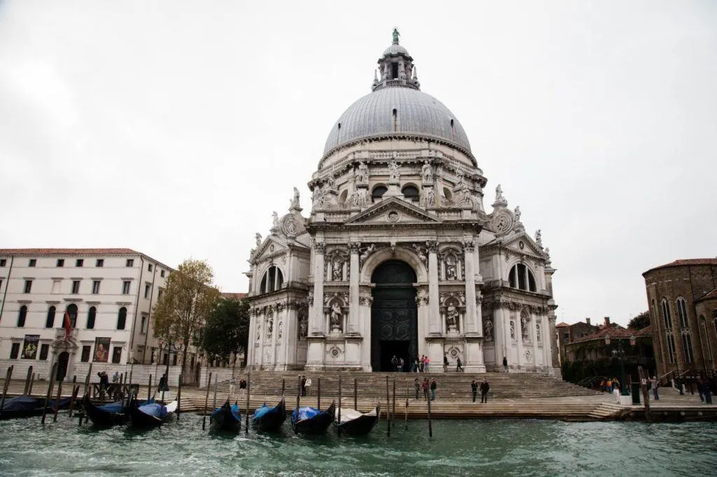 Gondolas moored in front of church in Venice.