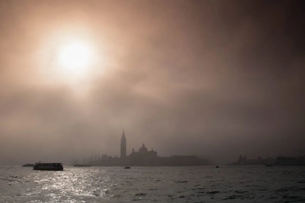 View of Venice from the water on a foggy day.