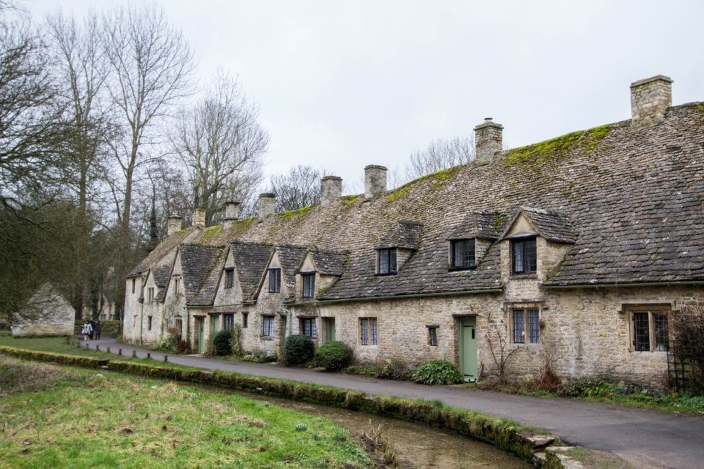 Row of old stone cottages in Bibury, England.