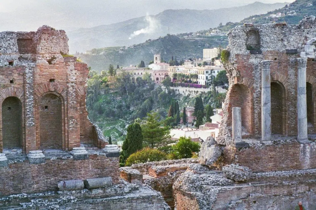 A view of the city seen through the ruins of the ancient Roman Amphitheater of Taormina.