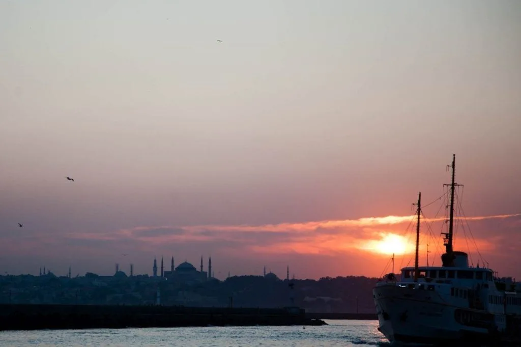 Sunset behind the striking domes and minarets of Istanbul's famous mosques.