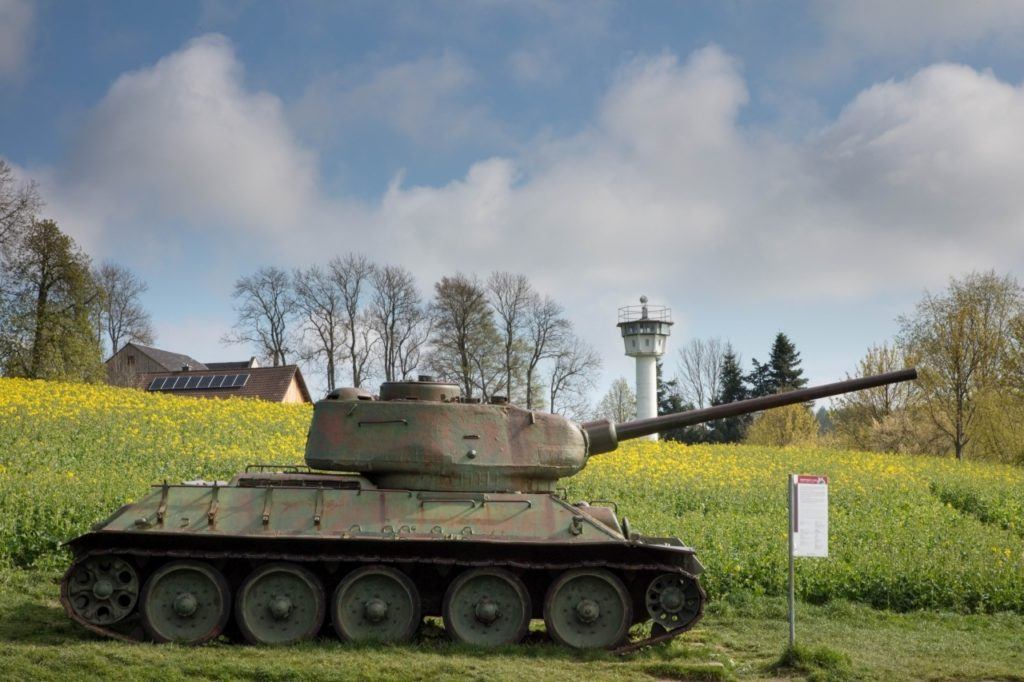 A tank and a guard tower impose order on Moedlareuth.