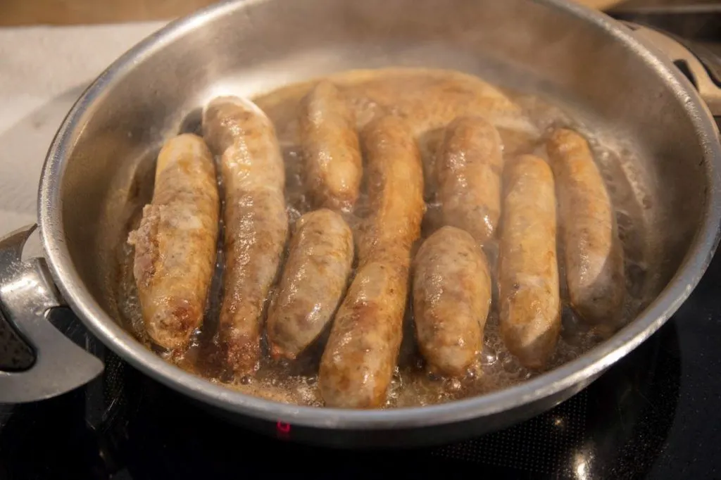 A pan of cooked homemade bratwurst after learning how to make wurst all day. 