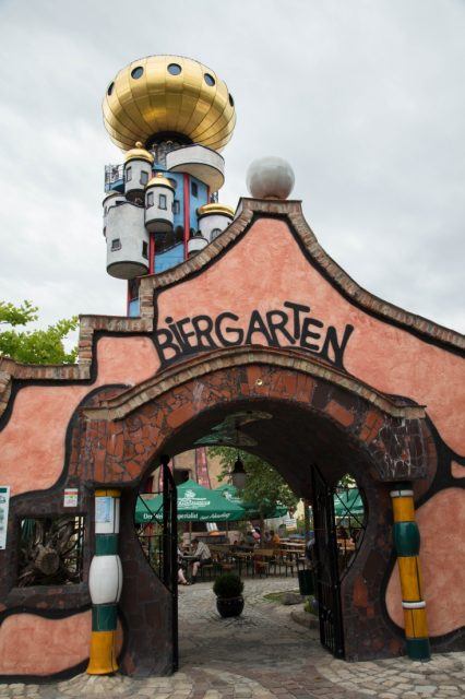 Entrance of Kuchlbauer beer garden with the Hundertwasser tower behind.